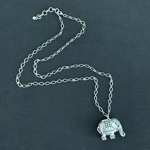 Lucky Brand long silver tone necklace with elephant pendant/locket